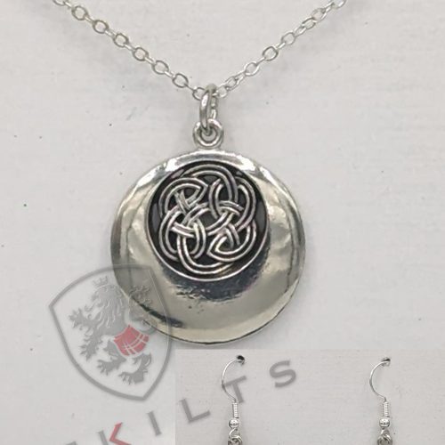 A silver pendant featuring an intricate black and white Celtic design, showcasing a rounded knot pattern.