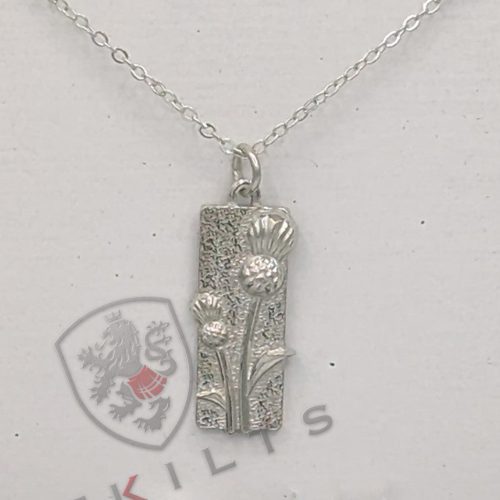 A silver necklace adorned with a rectangular pendant, complemented by a thistle design.