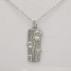 A silver necklace adorned with a rectangular pendant, complemented by a thistle design.